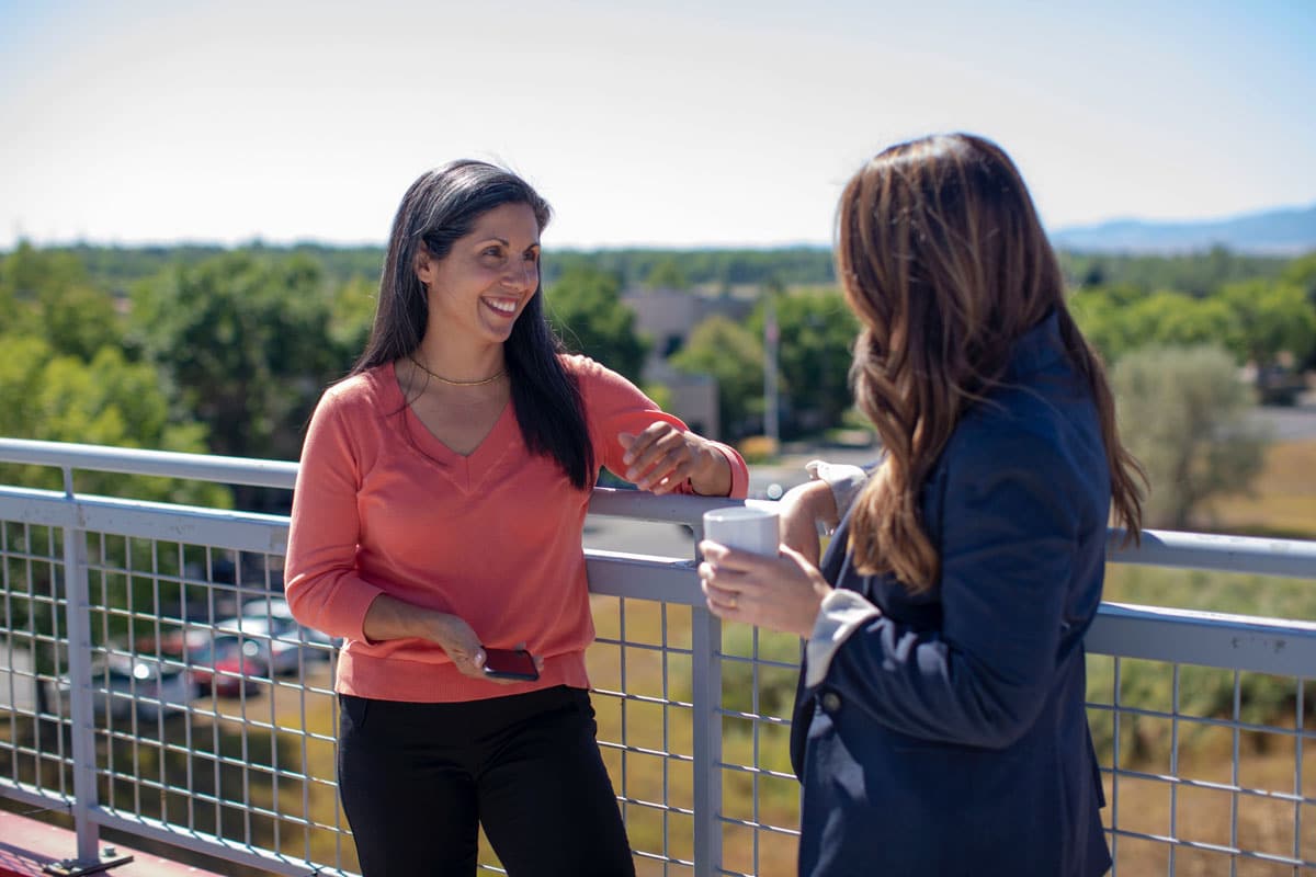 Two women chatting outside.